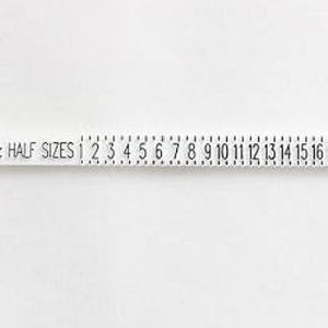 May include: White plastic ruler with black markings for measuring shoe sizes. The ruler shows sizes 1 through 17, with half sizes marked in between. The text "SIZE & HALF SIZES" is printed on the ruler, along with "PAT. PEND. 9101693".