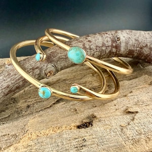 May include: A set of three ceramic mugs with a speckled, matte finish in cream, light grey, and dark grey. Each mug has a simple, minimalist design, suitable for coffee or tea.
