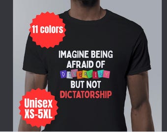 May include: Black t-shirt with white text that reads "Imagine being afraid of diversity but not dictatorship". The word "diversity" is spelled out with colorful letters.