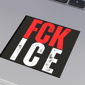 May include: A black square sticker with the words "FCK ICE" in bold, distressed white and red letters. The sticker is placed on a silver laptop.