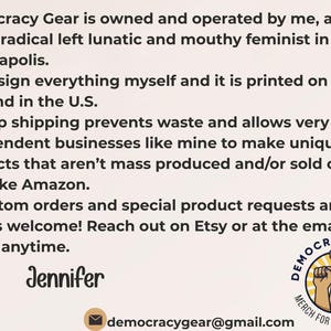May include: Text on a white background reads "Democracy Gear" and describes the business's values and services. Includes a logo with raised fists and the text "Merch for the Movement."