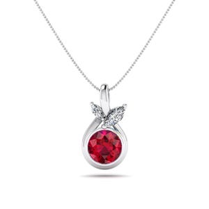 May include: A silver pendant necklace featuring a round, vibrant red gemstone. The pendant is accented with two white, leaf-shaped gemstones and hangs from a delicate silver chain. The jewelry is set against a white background.