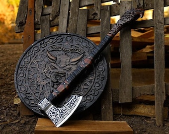 May include: A black and brown axe with a carved wooden handle and a shield with a wolf design. The axe blade is engraved with the text "CONQUERED WOLF NEVERLY FEARLESS FOREVER".