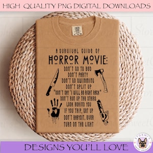 May include: A tan t-shirt featuring black text that reads A SURVIVAL GUIDE OF HORROR MOVIE: DON'T GO TO BED, DON'T PARTY, DON'T GO SWIMMING, DON'T SPLIT UP, DON'T SAY I WILL BE RIGHT BACK, DON'T RUN UP THE STAIRS, LOOK BEHIND YOU, IF YOU TRIP, GET UP, DON'T BABYSIT, EVER TURN ON THE LIGHT. The design includes a knife, an axe, a chainsaw, and a handprint graphic.