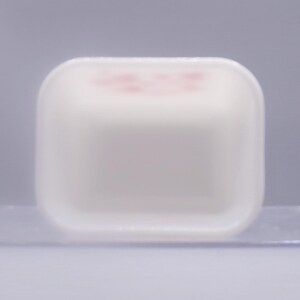 May include: White plastic square dish with a slightly raised rim. The dish is empty.