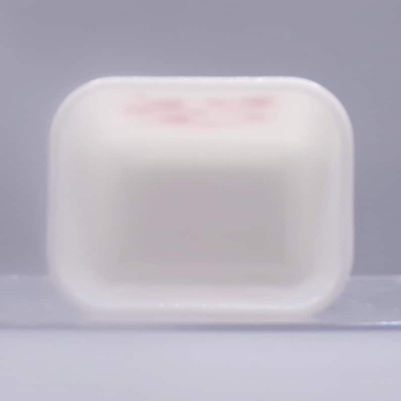 May include: White plastic square dish with a slightly raised rim. The dish is empty.