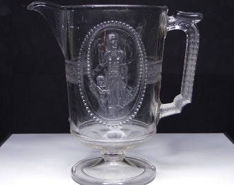Early American Pressed Glass Pitcher; Richards And Hartley Glass Co; R H #500 (OMN) AKA Cupid And Venus; Guardian Angel; Minerva c 1880