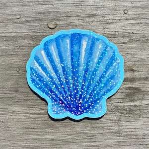 May include: A set of three ceramic mugs with a speckled, matte finish. The mugs are in shades of cream, light gray, and dark gray. Each mug has a simple, minimalist design, perfect for coffee or tea.