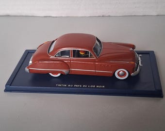 Un coche de Tintín del álbum: Tierra de Oro Negro