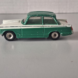 A green/white Triumph Herald from Dinky Toys
