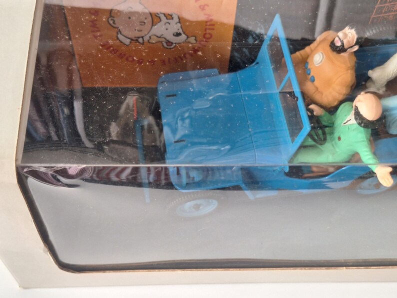 May include: A white ceramic mug with a black handle and the text "But First, Coffee" in a black, bold font. The mug is on a white surface.