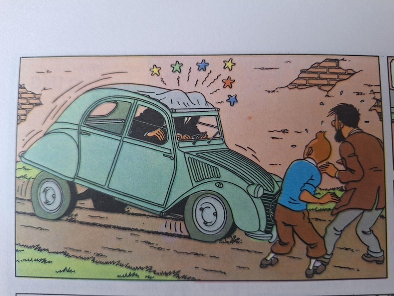 May include: Comic book panel featuring a light green vintage car with a dented roof, surrounded by stars. Two figures are running away from the car. The scene is set against a backdrop of a brick wall and a dirt road.