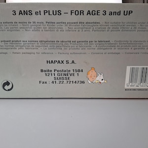 May include: A white ceramic mug with a black handle and the text "But First, Coffee" in a handwritten style. The mug is on a white surface. The mug is approximately 4 inches tall.