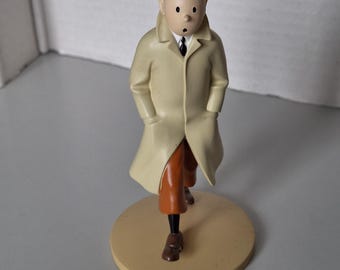 A figurine of Tintin in his raincoat