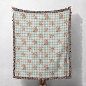 Floral gingham woven blanket displayed flat showing vintage botanical design
