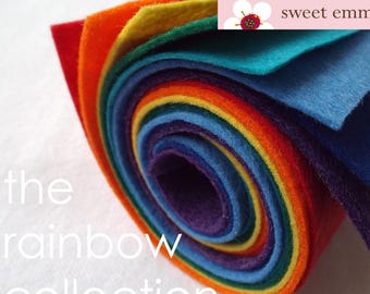 May include: A roll of felt fabric in rainbow colors, including red, orange, yellow, green, blue, indigo, and violet. The felt is rolled up and tied with a white string. The text "sweet emma jean" is visible on a pink tag.
