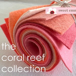 Op de afbeelding: Een rol viltstof in verschillende tinten roze en oranje, met het label "the coral reef collection" en "sweet emma jean".