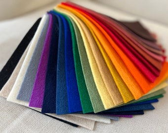 May include: A rainbow assortment of felt fabric swatches in various colors, including black, white, gray, purple, blue, green, yellow, orange, red, brown, and pink.