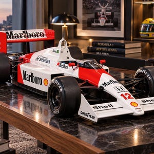 May include: A detailed scale model of a Formula 1 race car featuring a white and red livery with Marlboro, Honda, Shell, and Goodyear branding. The car displays the number 12 on the nose and rear wing, with black tyres and a cockpit area.