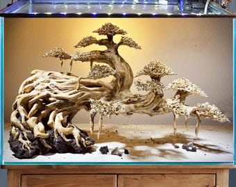 May include: An aquarium with a bonsai tree sculpture. The tree is made of light-colored wood and has multiple branches with small, textured leaves. The aquarium has a wooden cabinet base and a light fixture on top.