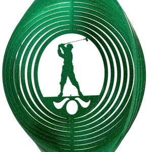 May include: Green metal wind spinner with a silhouette of a golfer swinging a club. The spinner has multiple layers of metal that spin in the wind.