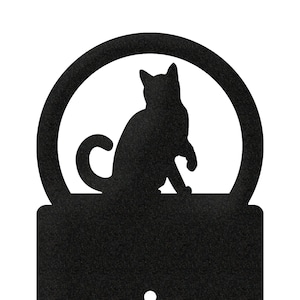 May include: Black metal light switch cover with a silhouette of a cat in a circle on top.
