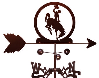 May include: A brown metal weather vane with a silhouette of a cowboy riding a bucking horse in a circle. The vane has four directional arrows with the letters N, S, E, and W.