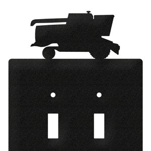May include: Black metal double light switch cover with a silhouette of a combine harvester on top.