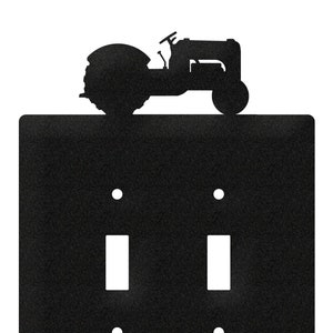May include: Black double light switch cover with a silhouette of a vintage tractor on top.
