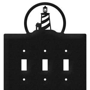 May include: Black metal light switch cover with a silhouette of a lighthouse in a circle at the top.