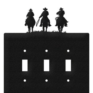 May include: Black metal light switch cover with three toggle switches and a silhouette of three cowboys riding horses at the top.