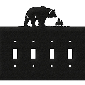 May include: Black metal light switch cover with four toggle switches and a silhouette of a bear and trees at the top.
