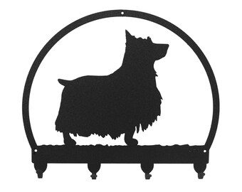 May include: Black metal key holder with a silhouette of a Yorkshire Terrier dog in a circle. The key holder has four hooks.
