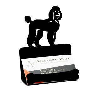 May include: Black metal business card holder featuring a silhouette of a poodle dog. The holder has a bone-shaped detail at the bottom and includes the text "SWEN PRODUCTS, INC STEEL GARDEN ART/DECOR".