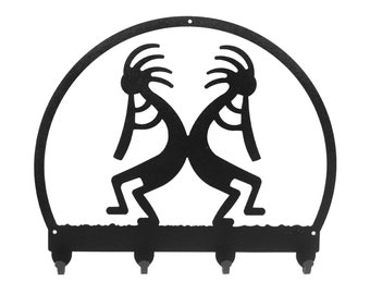 May include: Black metal key holder with a circular design featuring two stylized figures in a dancing pose. The key holder has four hooks.