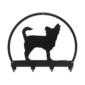 May include: Black metal key holder with a silhouette of a Chihuahua dog in a circle. The key holder has four hooks.