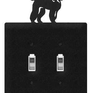 May include: Black light switch plate with a poodle silhouette on top. The plate has two toggle switches labeled "ON".