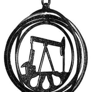 May include: Black metal wind chime with a silhouette of an oil derrick in the center. The chime is suspended from a hook at the top and has multiple rings.