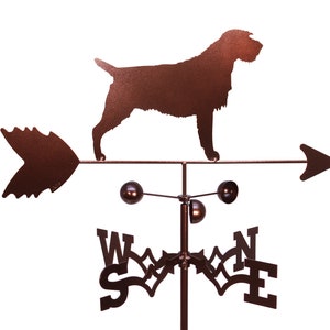 May include: A brown metal weather vane featuring a silhouette of a Wirehaired Pointing Griffon dog. The vane has a directional arrow and a compass rose with the letters N, S, E, and W.