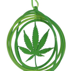May include: Green metal wind chime with a marijuana leaf design. The chime has a hook for hanging and is made of multiple concentric circles.