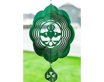 May include: Green metal wind spinner with a Celtic knot design and a shamrock-shaped bottom.