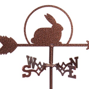 May include: A copper-colored metal rabbit weather vane with a compass rose and an arrow pointing to the east. The rabbit is in a circle with a sun behind it.