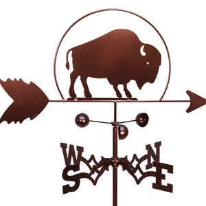 May include: A brown metal wind vane with a silhouette of a buffalo in a circle. The wind vane has a directional arrow and a compass rose with the letters N, S, E, and W.