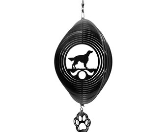 May include: Black metal wind spinner with a silhouette of a dog and a paw print hanging from the bottom.