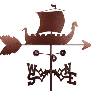 May include: A brown metal wind vane featuring a Viking ship with a sail and a dragon head. The wind vane has a compass rose with the letters N, S, E, and W.