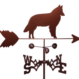 May include: A brown metal weather vane featuring a silhouette of a dog with a pointed tail. The vane has a directional arrow and a compass rose with the letters N, S, E, and W.