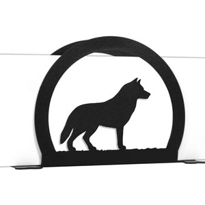 May include: Black metal napkin holder with a wolf silhouette in a circle.