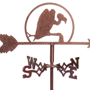 May include: A copper-colored metal wind vane featuring a silhouette of a vulture in a circle with an arrow pointing to the right. The wind vane also has a compass rose with the letters N, S, E, and W.
