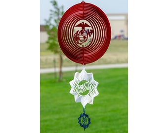 May include: Red, white and blue metal wind spinner with the US Marine Corps emblem, a star with a wavy American flag design, and a blue and white USA emblem.