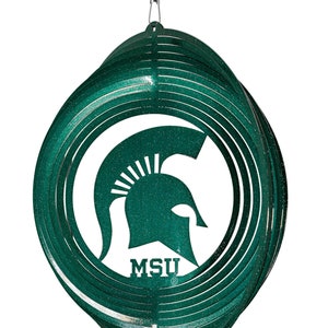 May include: Green metal wind spinner with a white Spartan helmet and the letters "MSU" in the center.
